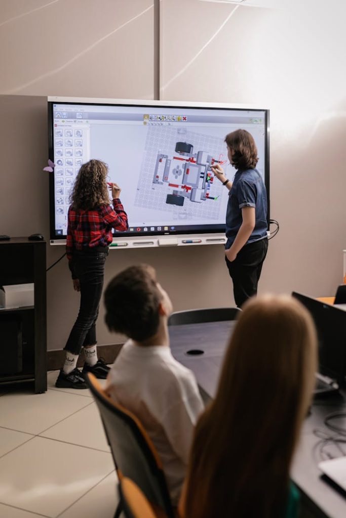 students-making-a-report-inside-the-classroom-7743257 Teens engaged in robotics teamwork in a modern classroom setting.
